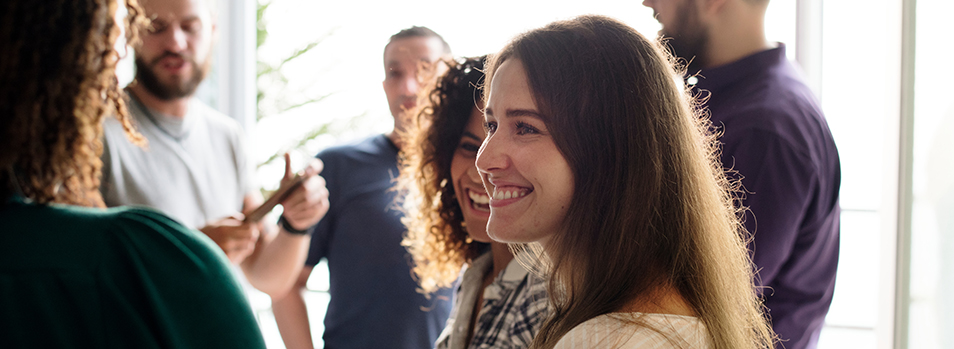 Friends at work happy at a meeting - Lisa D. Foster, Leadership Coaching & Training woman happy at a meeting because she knows what business coaching is