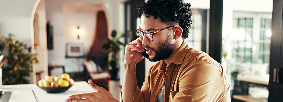 man and phone call with laptop in home for online consultation financial account query and invoice question Kitchen person and talking to contact for statement update and banking app help - Lisa D. Foster, Leadership Coaching & Training professional at home with questions to ask a coach before hiring a coach