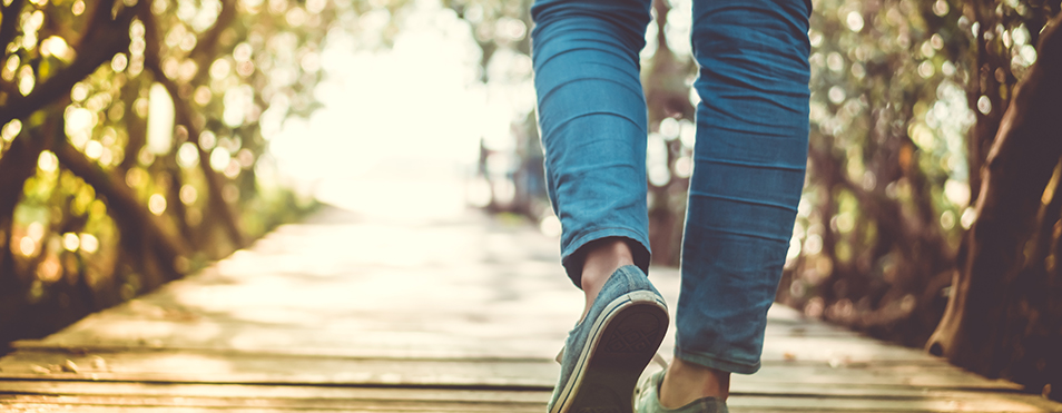 person walking on a bridge as a metaphor for moving forward from career moves leaders regret