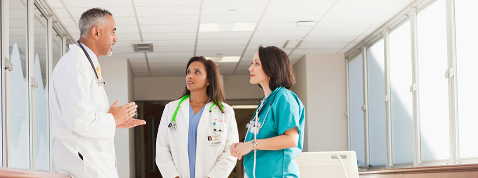 A doctor with nurses wondering about speaking up at work